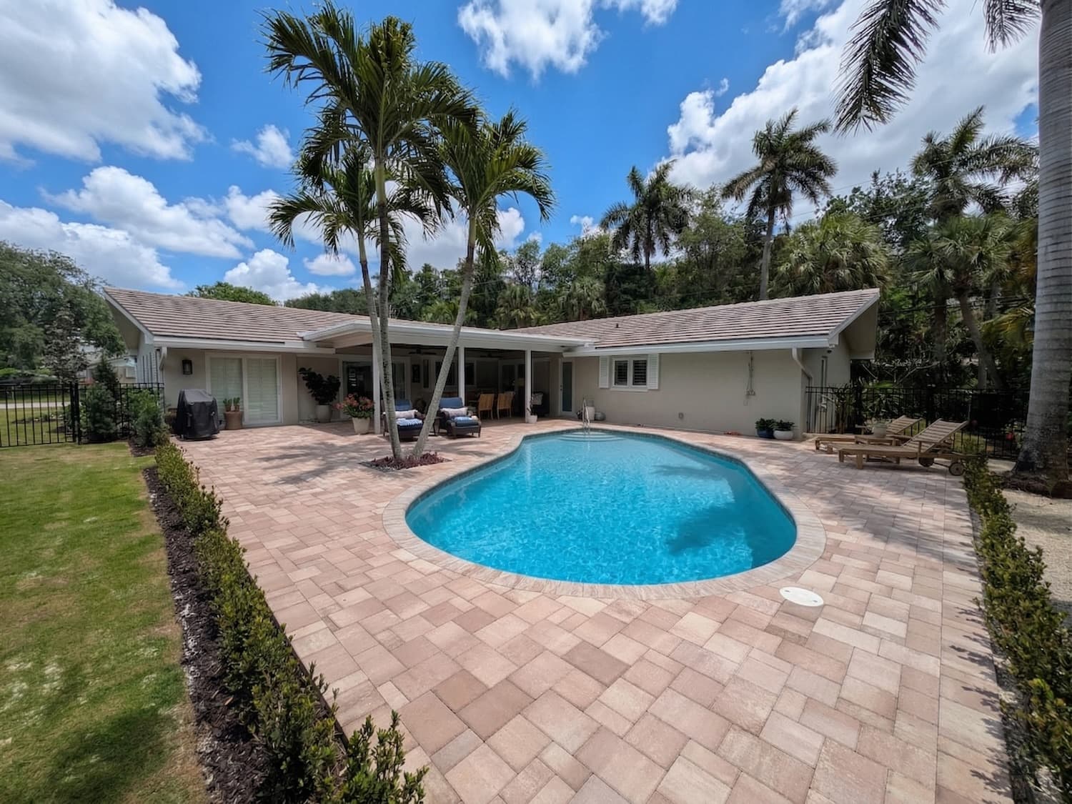 Florida backyard renovation with pool, paver patio, and covered lanai