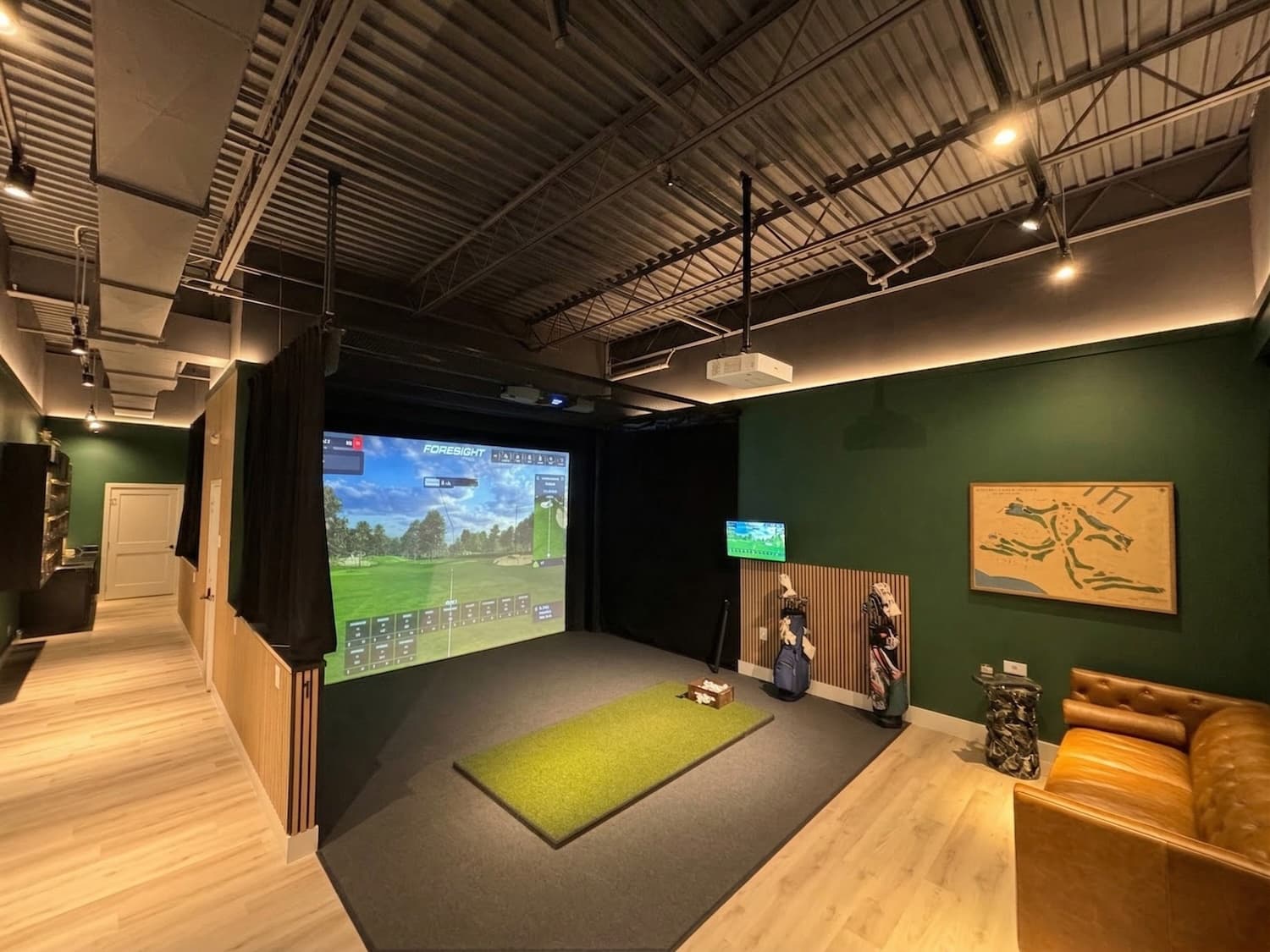 Albatross Den indoor golf simulator facility with Foresight simulator and lounge seating