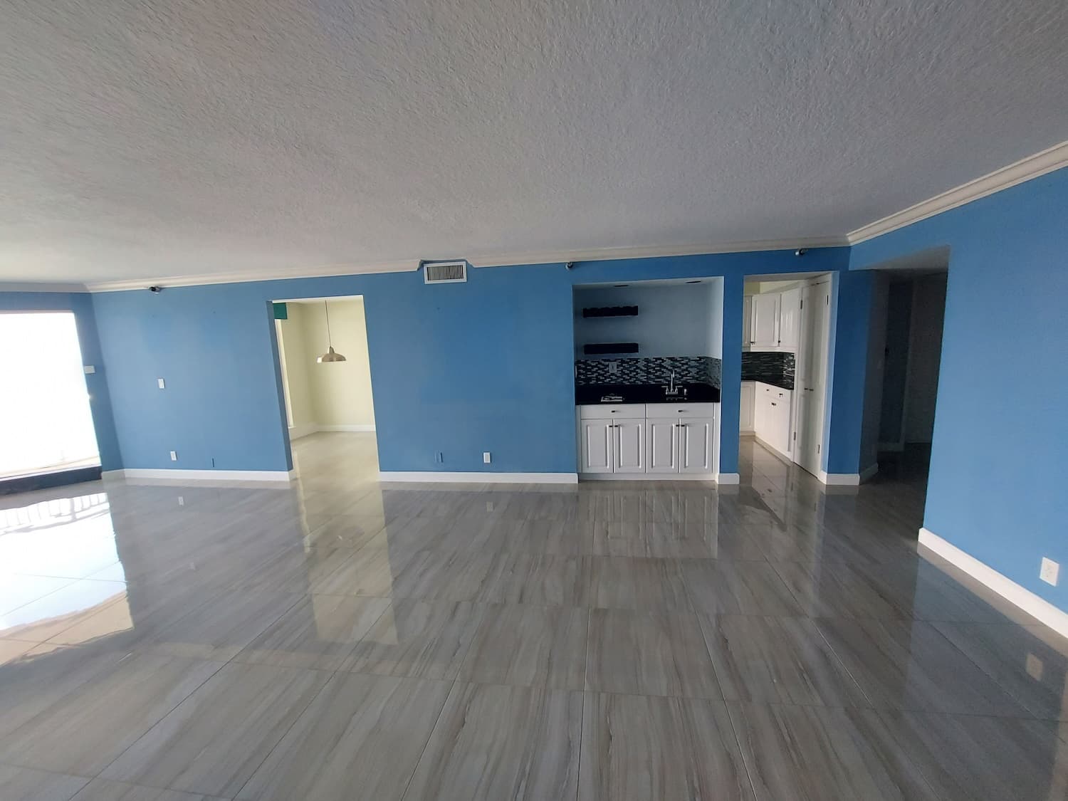Palm Beach condo before the remodel, with blue walls and gray floors