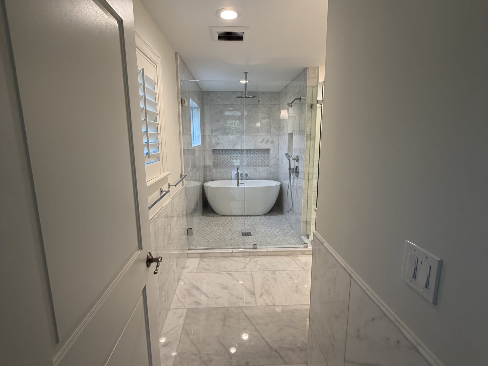 Freestanding tub and glass shower in the remodeled West Palm Beach primary bath